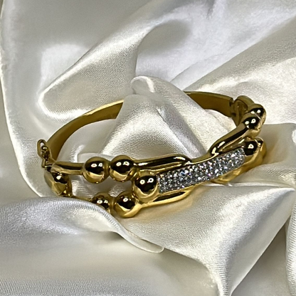 Braccialetto rigido ondulato con strass in acciao inox